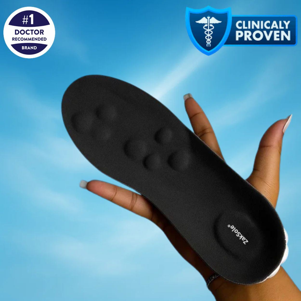 Black shoe insole held by a hand blue background